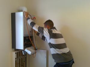 a Seal Beach plumbing tech checks the connection for a tankless water heater
